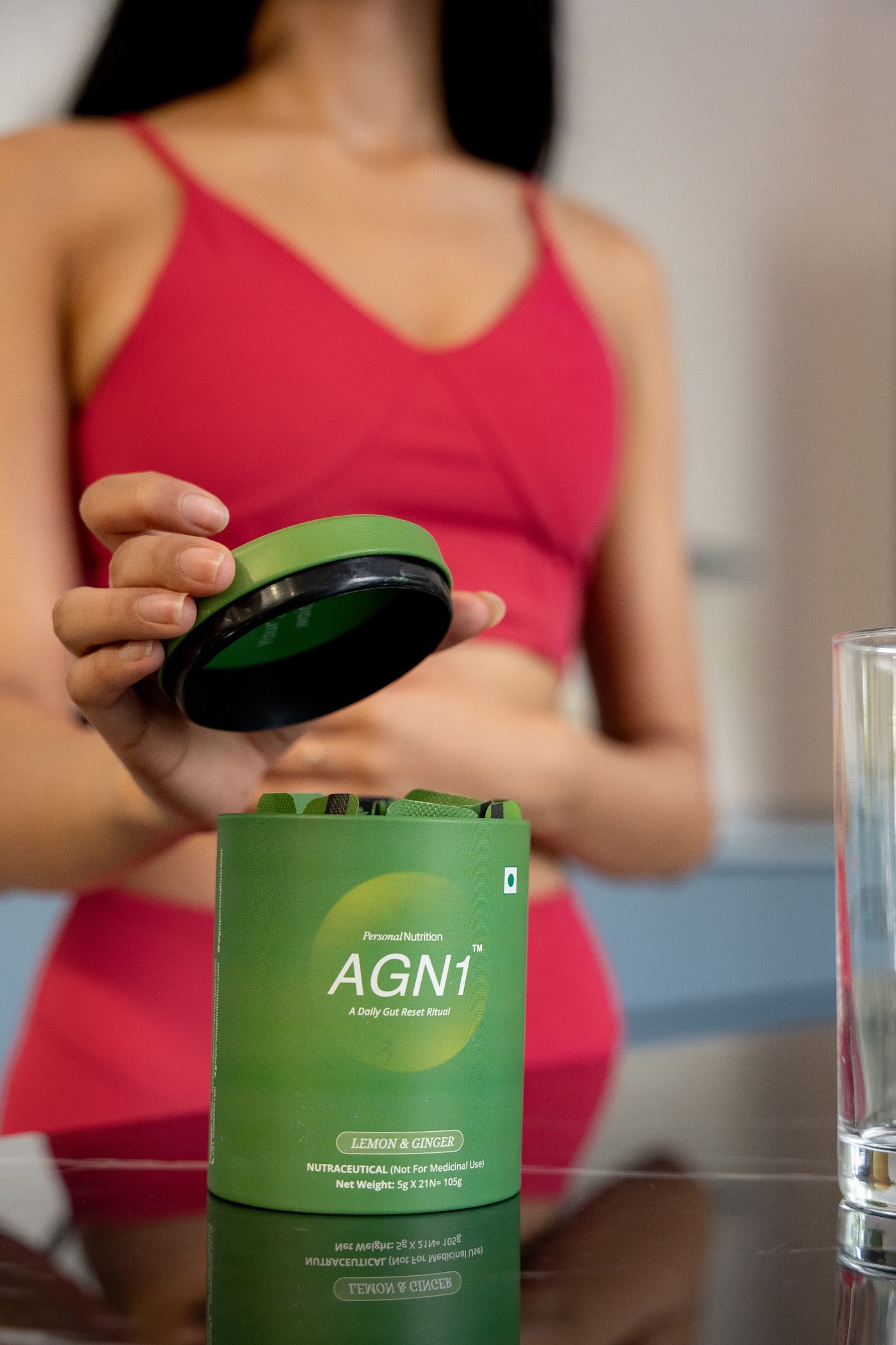 Woman in a pink top lifting the lid of an AGN1 tub