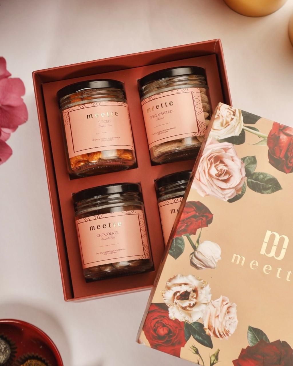 Meette gift box with four jars beside a rose-print box